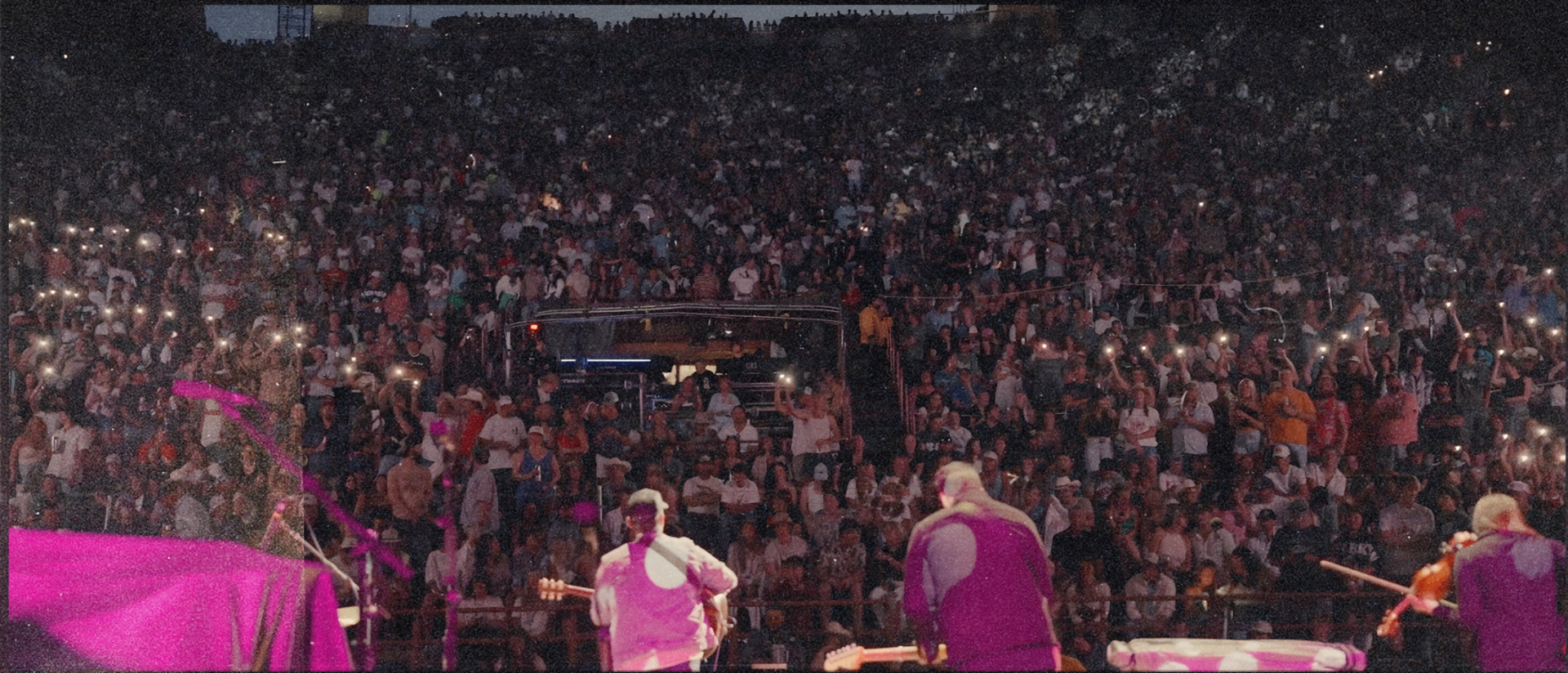 Stage view of a roaring crowd at sunset — the life this plan leads to
